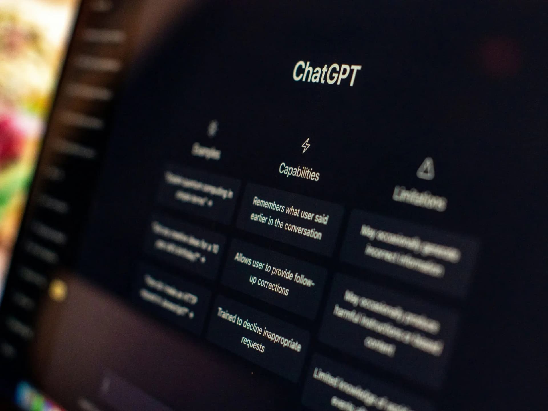 Close-up of the ChatGPT start screen on a laptop, listing examples, capabilities and limitations